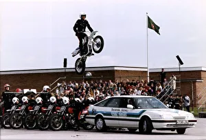 Army Regiments Royal Signals White Helmets on motorbikes doing a stunt over a car Army Regiments Royal Signals White Helmets on motorbikes doing a stunt over a car