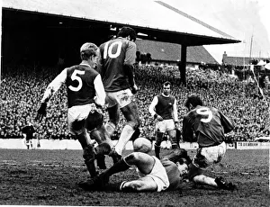 with Arsenal goalkeeper on the ground where he injured his hand in a melee involving John with Arsenal goalkeeper on the ground where he injured his hand in a melee involving John
