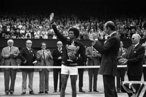 Arthur Ashe receives the trophy from the Duke of Kent after he defeated the defending Arthur Ashe receives the trophy from the Duke of Kent after he defeated the defending
