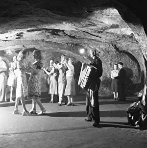 The audience of a performance of the Pirates of Penzance in the caves in the cliffs above The audience of a performance of the Pirates of Penzance in the caves in the cliffs above