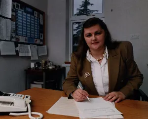 Audrey Baxter of Baxters Food mustard jacket white blouse pen papers Audrey Baxter of Baxters Food mustard jacket white blouse pen papers