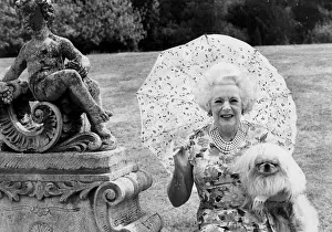 Barbara Cartland with pekinese dog in garden of her home - August 1976 20/08/1976 Barbara Cartland with pekinese dog in garden of her home - August 1976 20/08/1976
