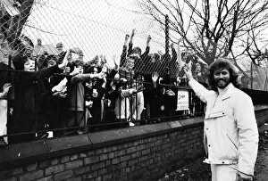 Barry Gibb of the Bee Gees pop group waves to children outside the gates of his former Barry Gibb of the Bee Gees pop group waves to children outside the gates of his former