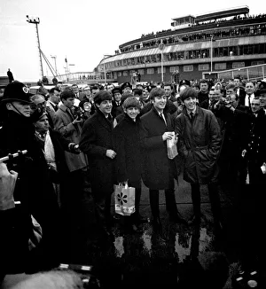 The Beatles arrive at London airport from Sweden. Surrounded by police, press and fans The Beatles arrive at London airport from Sweden. Surrounded by police, press and fans