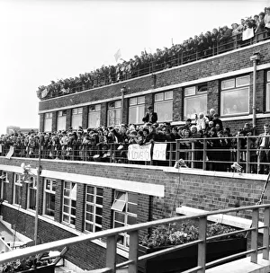 Beatles fans packed onto a building terrace and rooftop as they try to get a glimpse of Beatles fans packed onto a building terrace and rooftop as they try to get a glimpse of