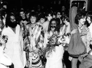 The Beatles with the Maharishi Mahesh Yogi who is clutching bundles of flowers Beatles The Beatles with the Maharishi Mahesh Yogi who is clutching bundles of flowers Beatles