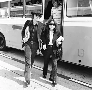Former Beatles singer and songwriter John Lennon and wife Yoko Ono holding hands as they Former Beatles singer and songwriter John Lennon and wife Yoko Ono holding hands as they