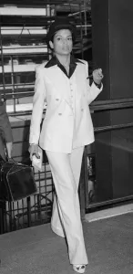 Bianca Jagger, wife of Mick Jagger, in white suit and bowler hat with silver topped cane Bianca Jagger, wife of Mick Jagger, in white suit and bowler hat with silver topped cane