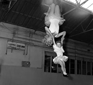 Billy Smart's Circus Trapeze artists swinging through the air December Billy Smart's Circus Trapeze artists swinging through the air December