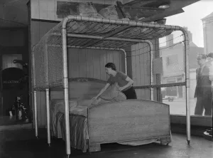 Birmingham furniture store displays in its shop window, a bed air raid protection frame Birmingham furniture store displays in its shop window, a bed air raid protection frame