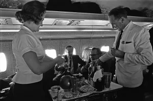 BOAC Steward and Stewardess serving drinks during a proving flight between Heathrow BOAC Steward and Stewardess serving drinks during a proving flight between Heathrow