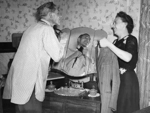Bombardier Reg Kraushaar of Deptford and wife, pictured putting on his tie Bombardier Reg Kraushaar of Deptford and wife, pictured putting on his tie