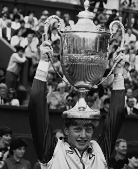 Images Dated 16th July 1985: Boris Becker tennis holding the Wimbledon Trophy on top of his head after becoming