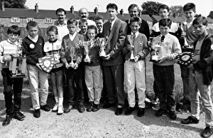 Boro footballer, Gary Robinson (centre) presents the trophies to the captains of winning Boro footballer, Gary Robinson (centre) presents the trophies to the captains of winning