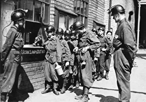 Boy trainees get their lamps before going below to the Ashington Colliery Company' Boy trainees get their lamps before going below to the Ashington Colliery Company'