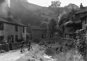Two boys out on their bicycles near a stream in the Peak District village of Castletown Two boys out on their bicycles near a stream in the Peak District village of Castletown