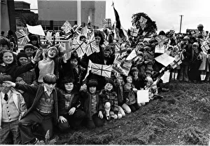 Boys and girls eagerly await the arrival of Queen Elizabeth II near Wrexham , Wales Boys and girls eagerly await the arrival of Queen Elizabeth II near Wrexham , Wales