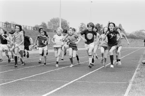 Boys and girls take part in a race at their school sports day. 20th June 1979 Boys and girls take part in a race at their school sports day. 20th June 1979