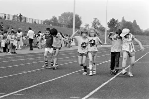 Boys and girls tied together as they take part in the Three Legged race at their school Boys and girls tied together as they take part in the Three Legged race at their school