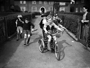 Boys playing on a council estate as one of their mothers looks on, London. 1955 Boys playing on a council estate as one of their mothers looks on, London. 1955