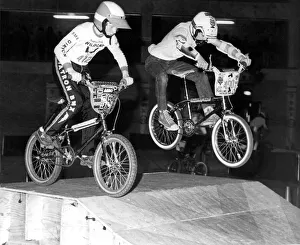 Two boys test a course obstacle with their BMX bikes Two boys test a course obstacle with their BMX bikes