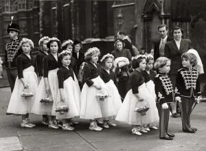 Two boys tressed as toy soldiers marshalling a long line of bridesmaids outside St Two boys tressed as toy soldiers marshalling a long line of bridesmaids outside St