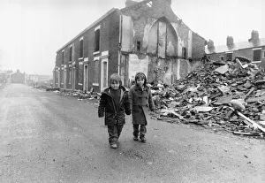 Two boys walk pass the partially demolished row of terrace houses in Blackburn May Two boys walk pass the partially demolished row of terrace houses in Blackburn May
