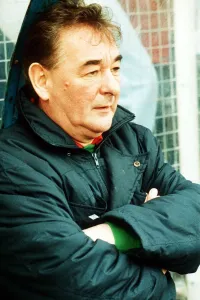 Brian Clough football manager sitting on team bench in football jacket with arms folded Brian Clough football manager sitting on team bench in football jacket with arms folded