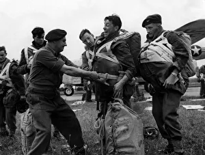 British Paratroops Army Soldiers August 1952 An officer tightens a chute for a British Paratroops Army Soldiers August 1952 An officer tightens a chute for a