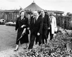 British Prime Minister Margaret Thatcher is led by Sir Leslie Young through the Victorian British Prime Minister Margaret Thatcher is led by Sir Leslie Young through the Victorian