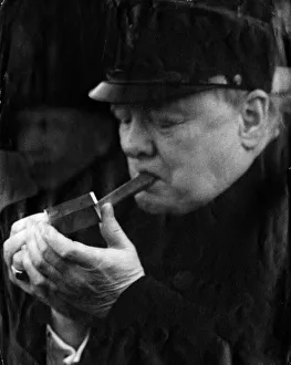 British Prime Minister Winston Churchill lights up one of his famous cigars British Prime Minister Winston Churchill lights up one of his famous cigars