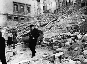 British Prime Minister Winston Churchill surveys the destruction in the dockyard area of British Prime Minister Winston Churchill surveys the destruction in the dockyard area of