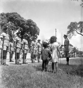 British soldiers marching in Georgetown, British Guiana watched by local citizens British soldiers marching in Georgetown, British Guiana watched by local citizens