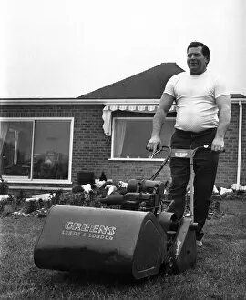 Images Dated 15th April 1971: British wrestler Count Bartelli at the helm of a huge lawn mower on the lawn of his home