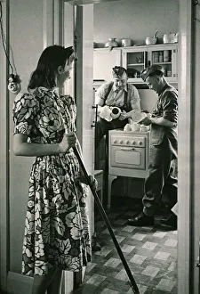 Canadian soldiers washing-up while english woman sweeps floor Canadian soldiers washing-up while english woman sweeps floor