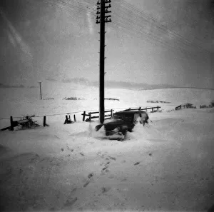 Car abandoned in deep snow after a heavy snowfall. February 1953 D738 Car abandoned in deep snow after a heavy snowfall. February 1953 D738