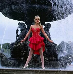 Images Dated 1st July 1987: Carol Smillie model TV presenter wearing red dress standing ion front of a water fountain
