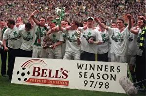 Celtic football players celebrate winning the championship 1998 with trophy cup winners Celtic football players celebrate winning the championship 1998 with trophy cup winners