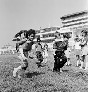 Children carrying their partners on their backs during a horse and jockey style egg Children carrying their partners on their backs during a horse and jockey style egg