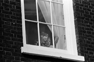 The children of Chancellor of the Exchequer Nigel Lawson watching from a window of 11 The children of Chancellor of the Exchequer Nigel Lawson watching from a window of 11