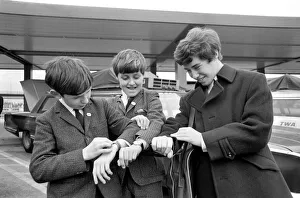 Three children check their watches against local US time on arrival in New York Three children check their watches against local US time on arrival in New York