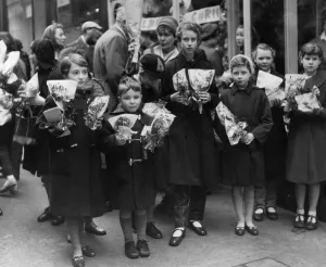 Children crowd outside a florists after buying thier flower for Mothering Sunday Children crowd outside a florists after buying thier flower for Mothering Sunday