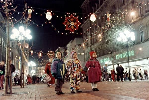 Images Dated 19th November 1993: Three children only have eyes for the colourful display of Christmas lights in Church