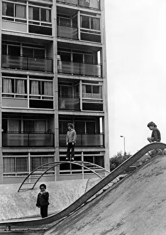 Children playing on play equipment on land between flats at Hillfields, Coventry Children playing on play equipment on land between flats at Hillfields, Coventry