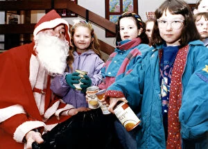 Images Dated 11th December 1991: Children turned the tables on Santa at the Billingham Forum - taking gifts to him
