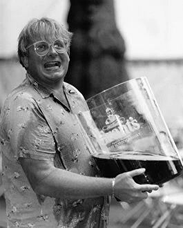 Images Dated 9th July 1989: Christopher Biggins with giant glass of Grants Whiskey 1989