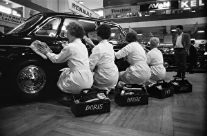 Four cleaning ladies polishing up one of the motors at the Earls Court Motor show Four cleaning ladies polishing up one of the motors at the Earls Court Motor show