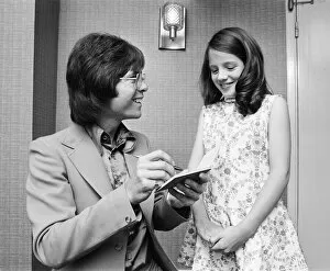 Images Dated 3rd June 1973: Cliff Richard signing autograph for a young fan, he is starring in Take Me High