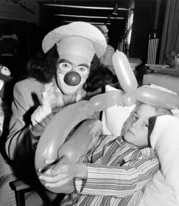 The clown Windy Blow visiting Middlesbrough Hospital, seen with a child holding a balloon The clown Windy Blow visiting Middlesbrough Hospital, seen with a child holding a balloon