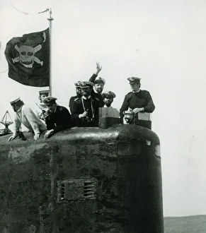 The conning tower of HMS Conqueror with the captain and crew members flying the jolly The conning tower of HMS Conqueror with the captain and crew members flying the jolly